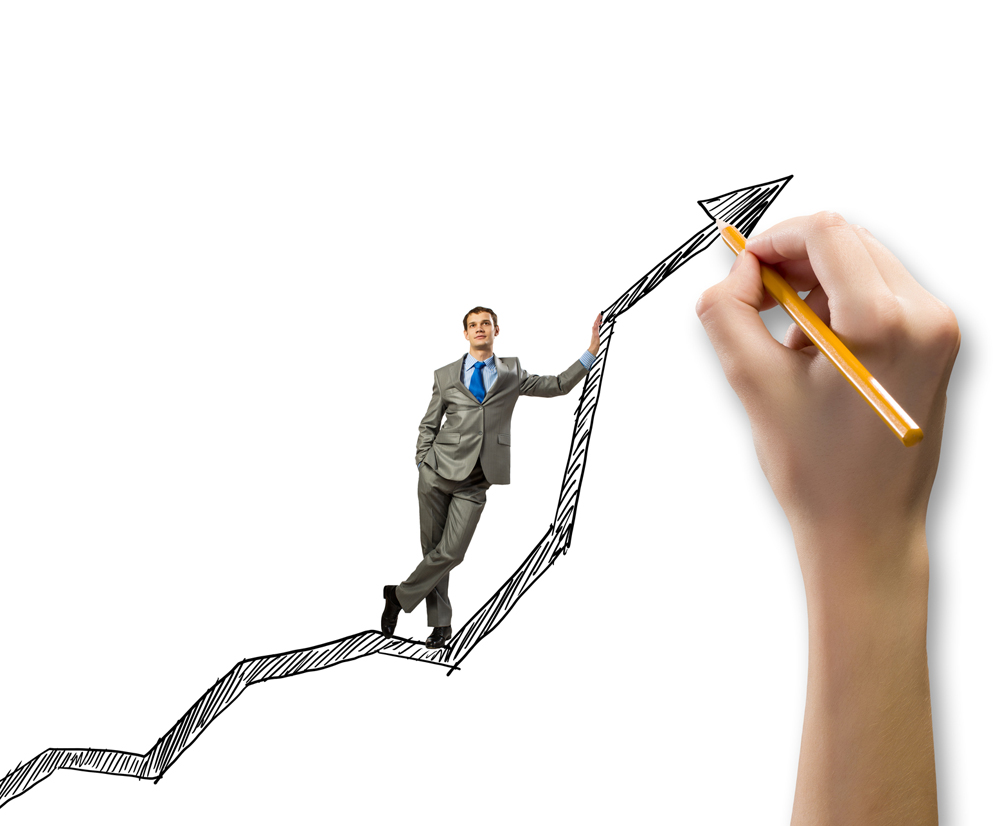 Young businessman standing on drawn graph arrow
